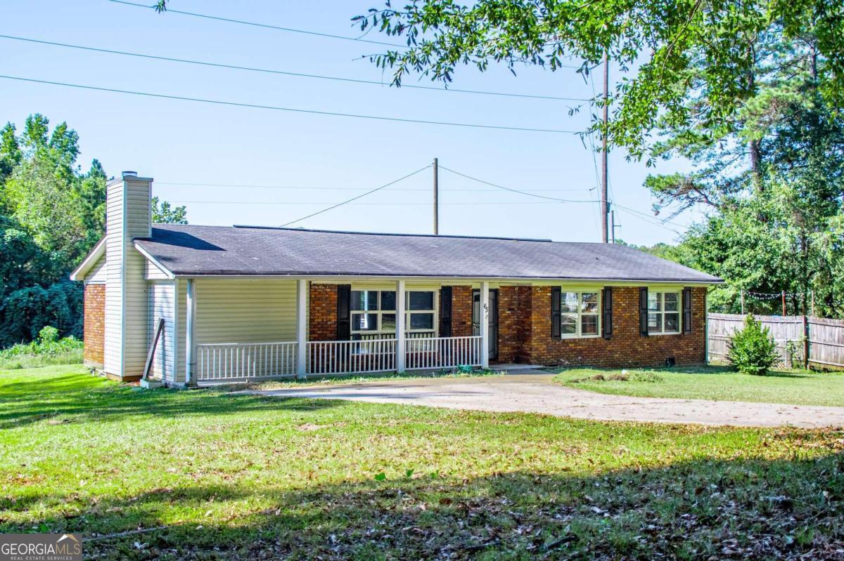 a front view of house with yard and green space