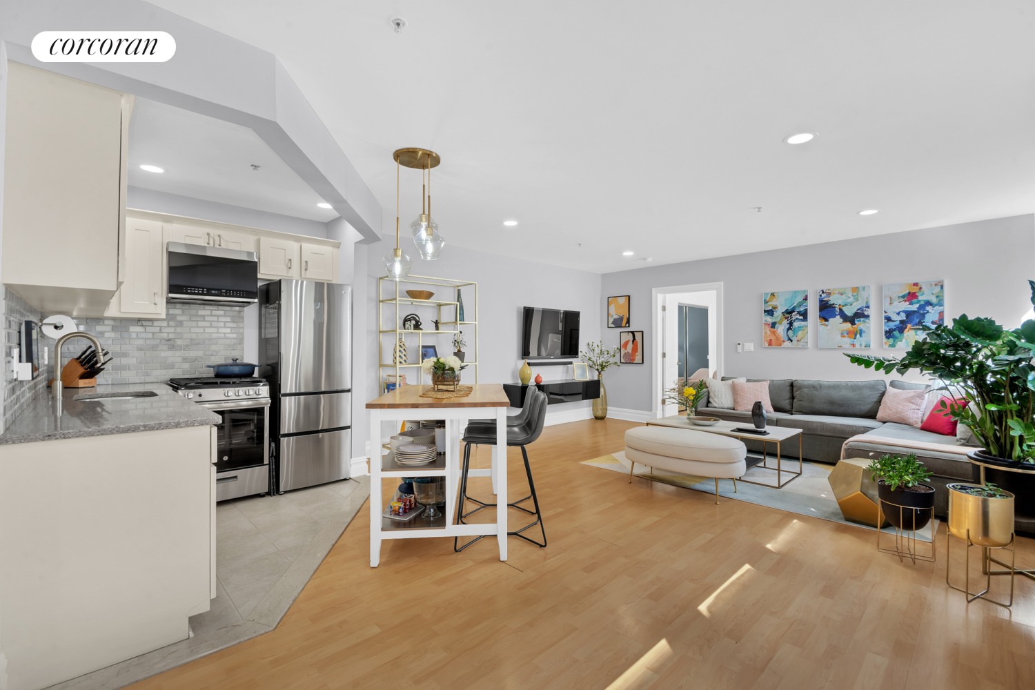 a living room with furniture and a kitchen view