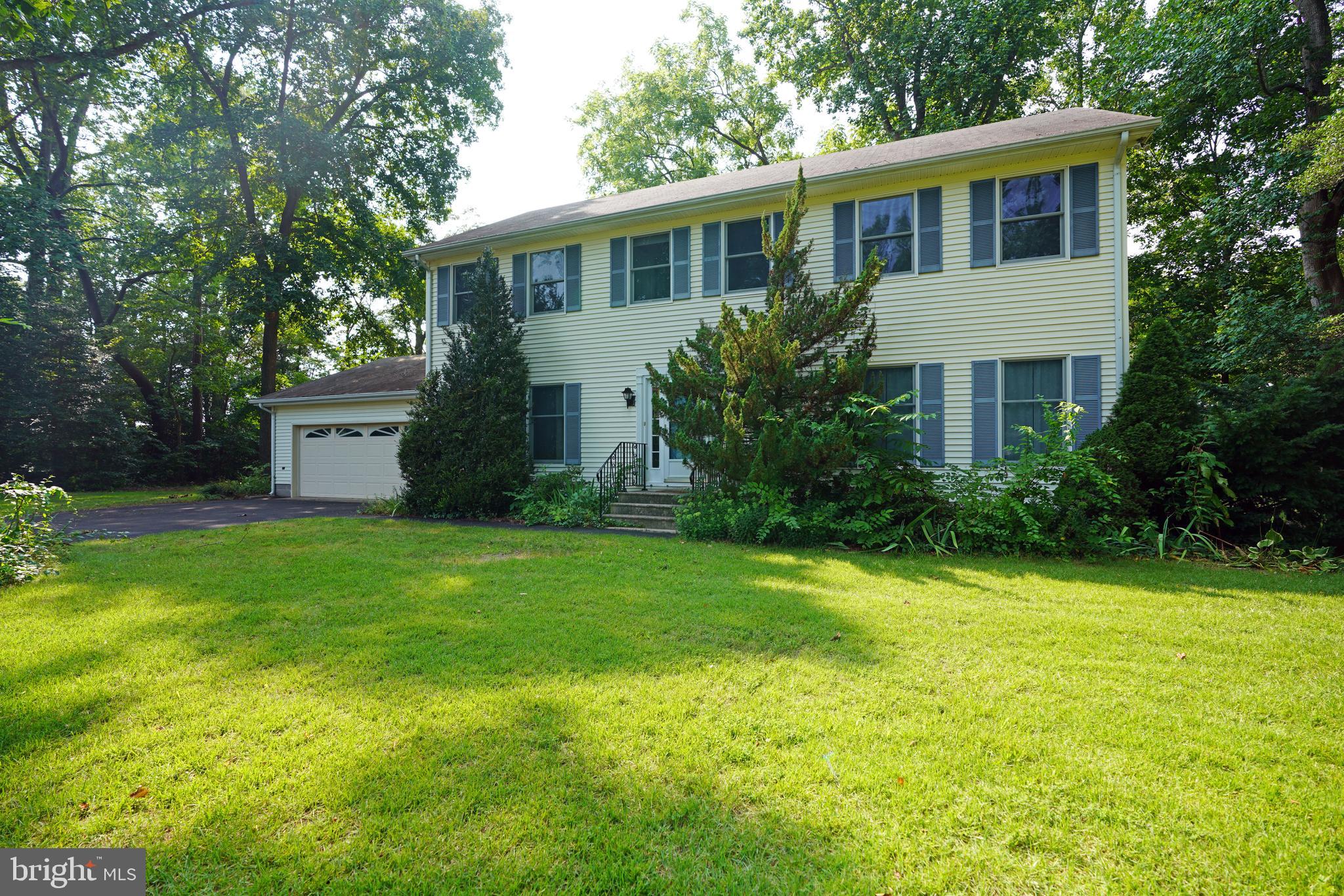 a front view of house with yard and trees