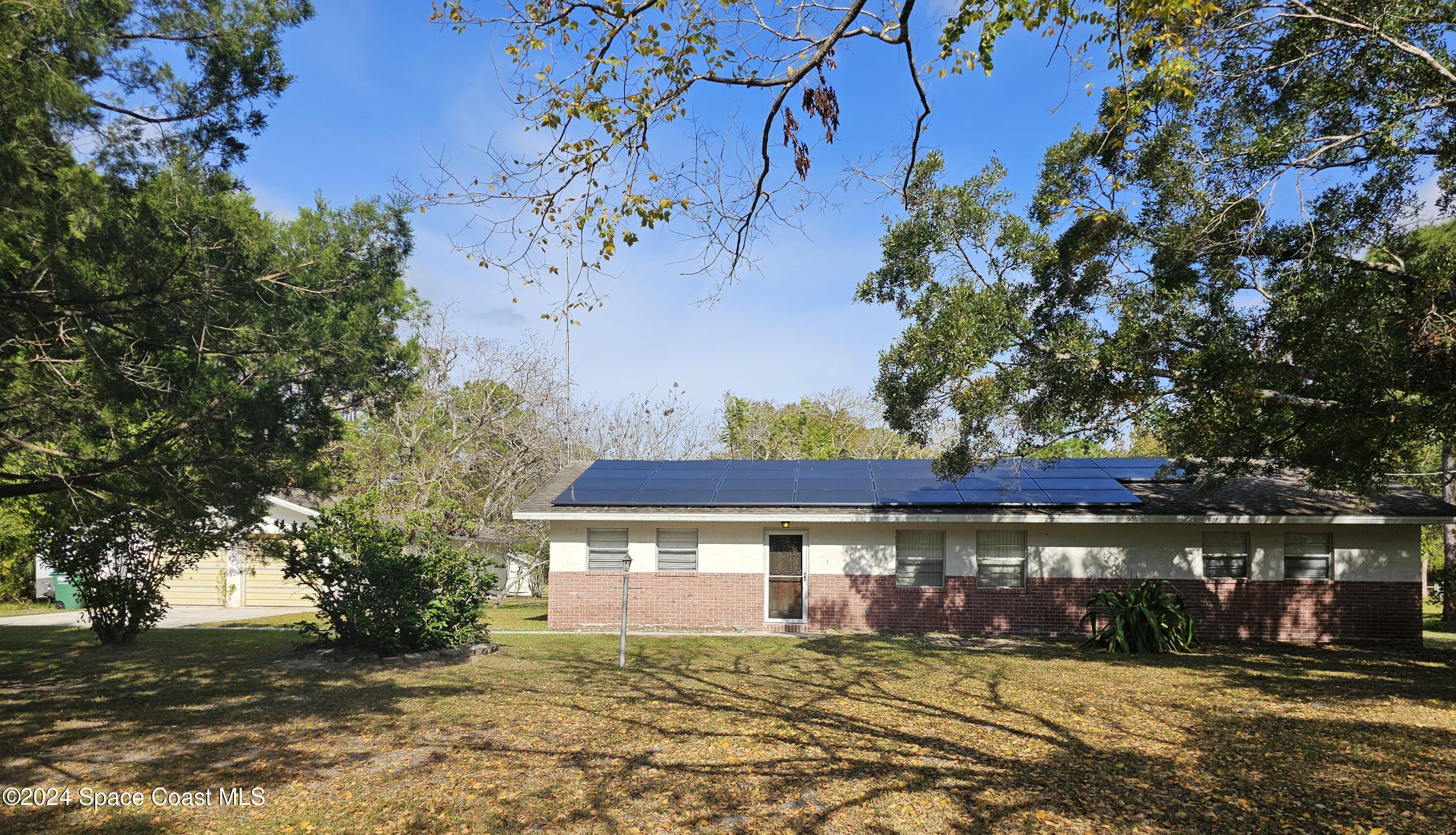 a view of house with yard