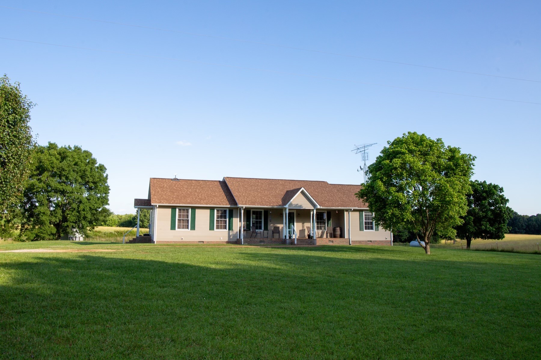 a front view of house with yard and green space