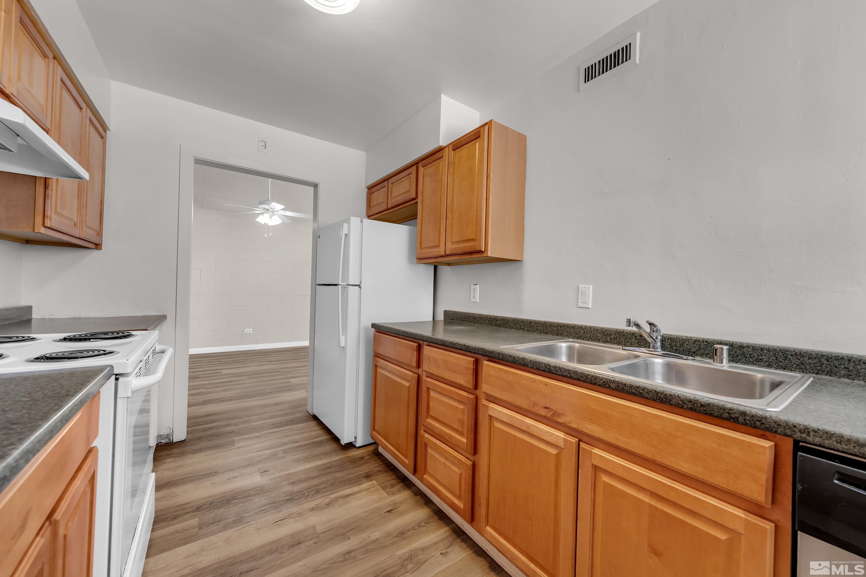 a kitchen with stainless steel appliances granite countertop a sink and a stove top oven