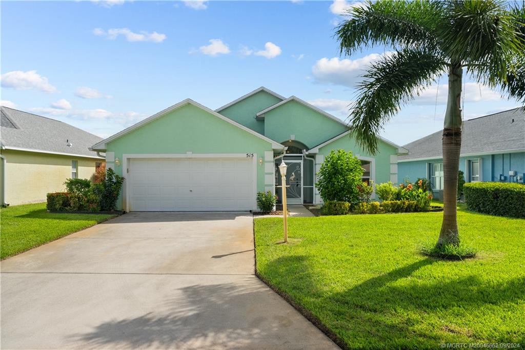 a front view of house with yard and green space