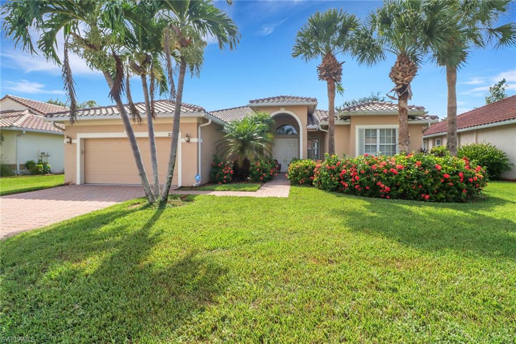 Mediterranean / spanish-style home featuring a front yard and a garage