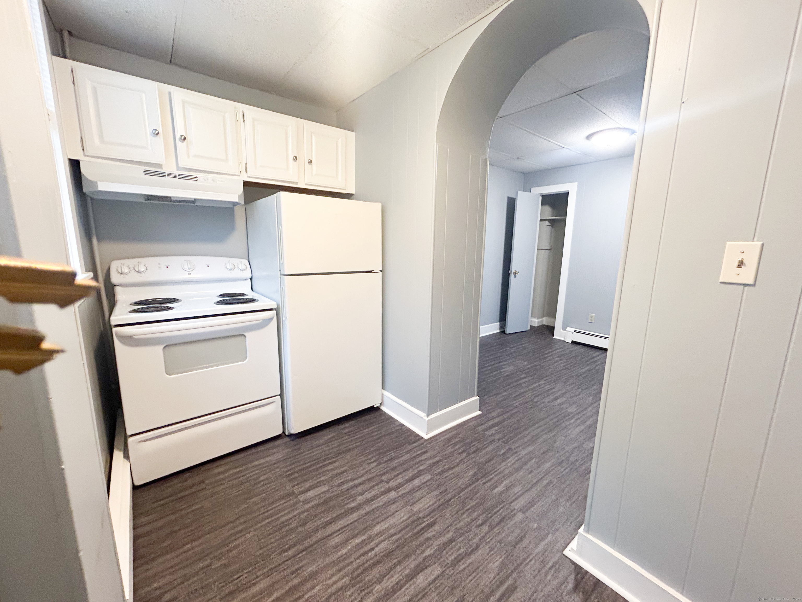 a view of a kitchen with wooden floor