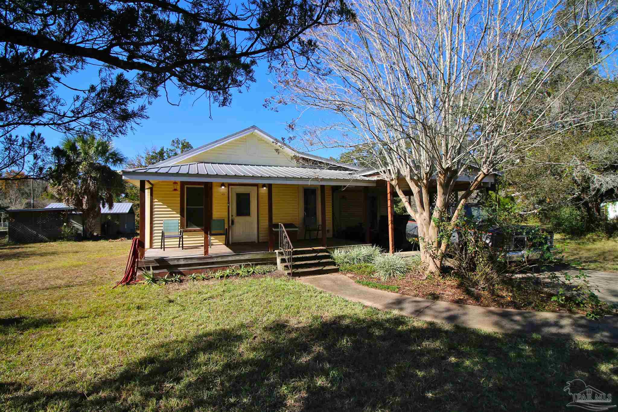 a front view of a house with a garden