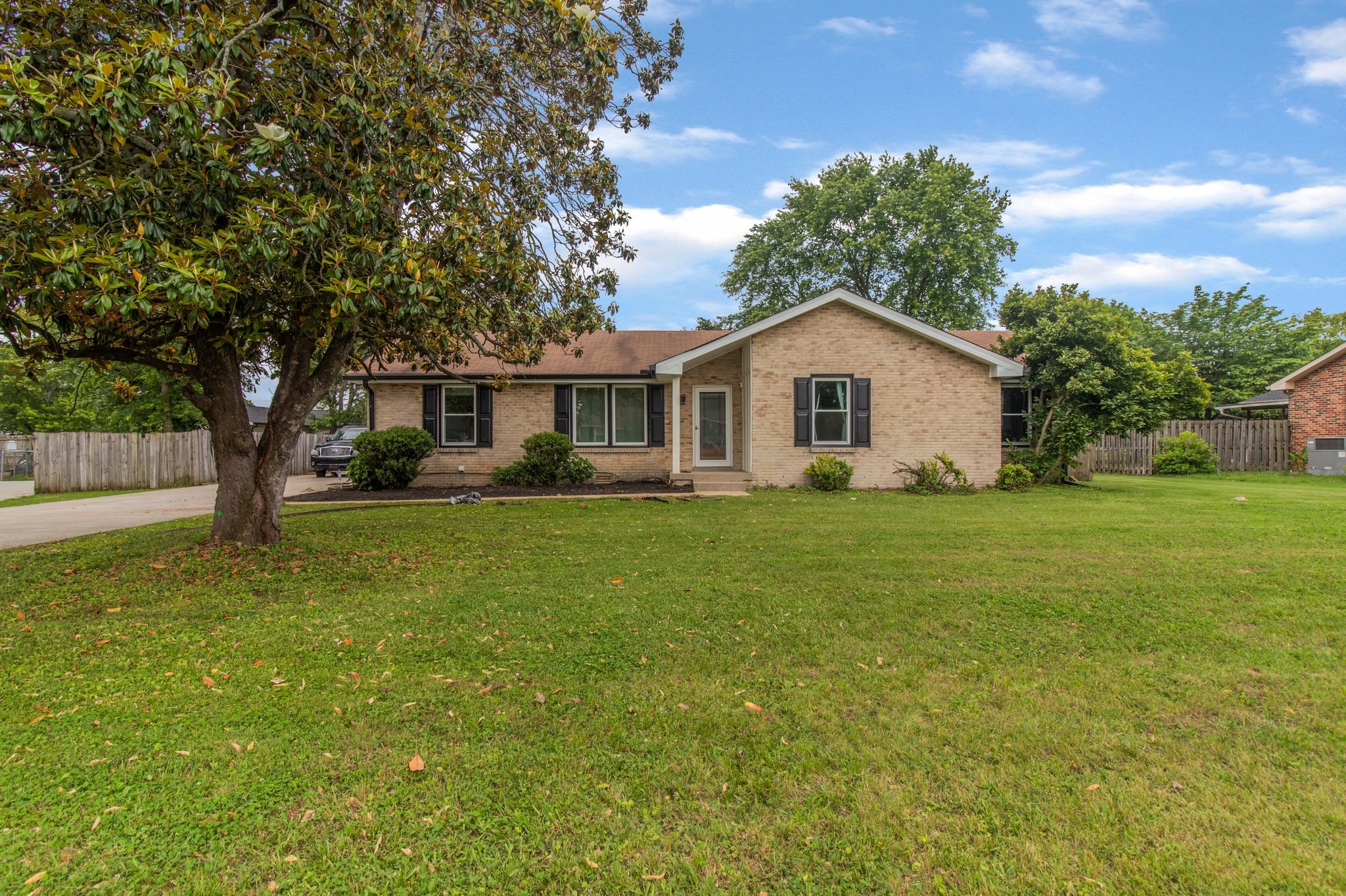 a front view of house with yard and green space