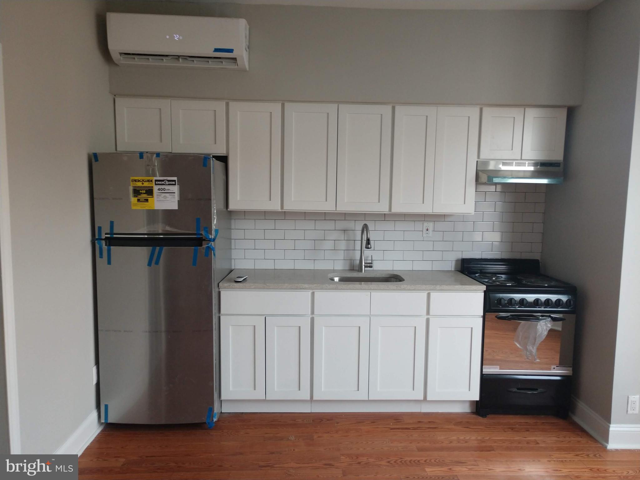 a kitchen with stainless steel appliances granite countertop a refrigerator stove and sink