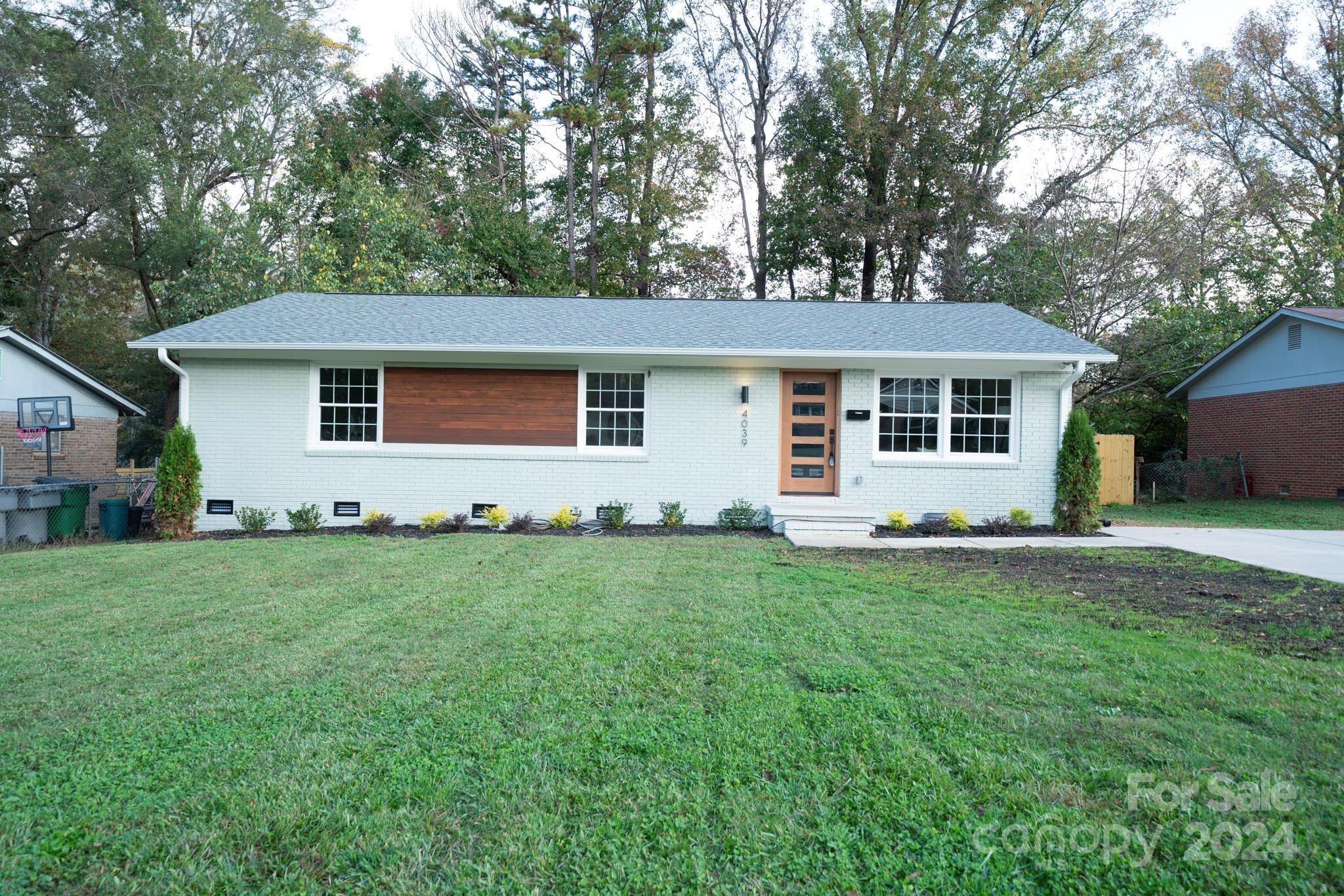 a front view of house with yard and green space