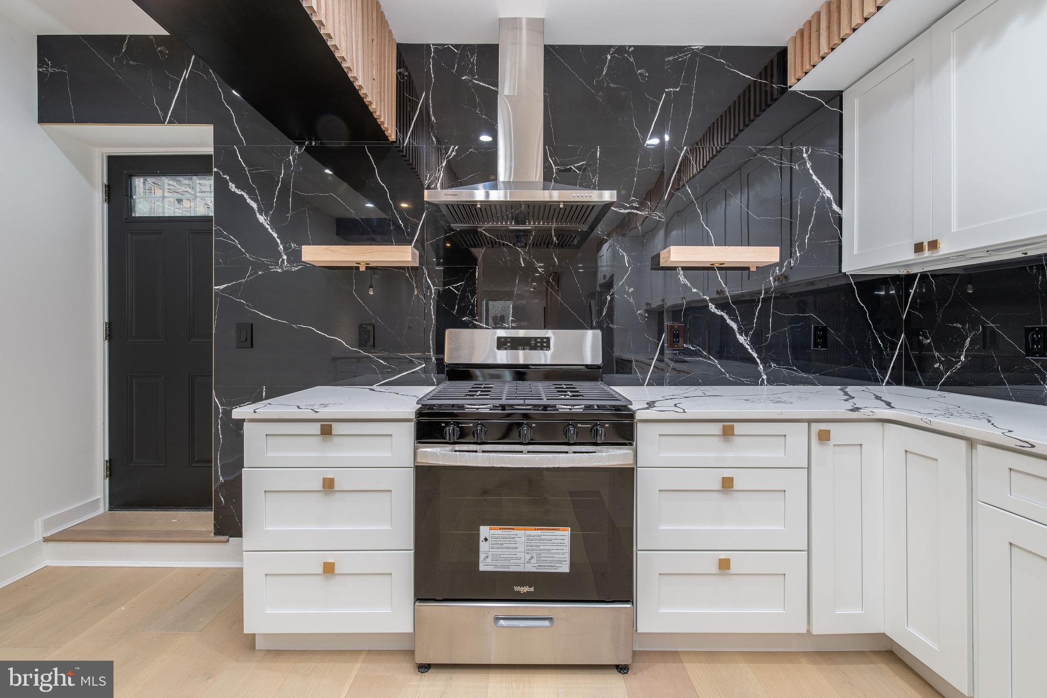 a stove top oven sitting inside of a kitchen