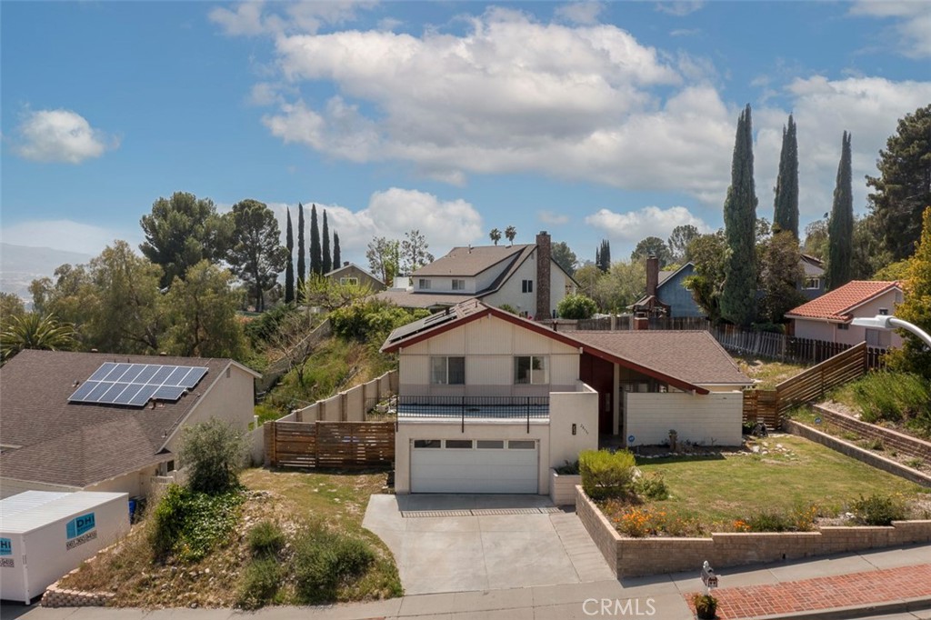 a aerial view of a house next to a yard