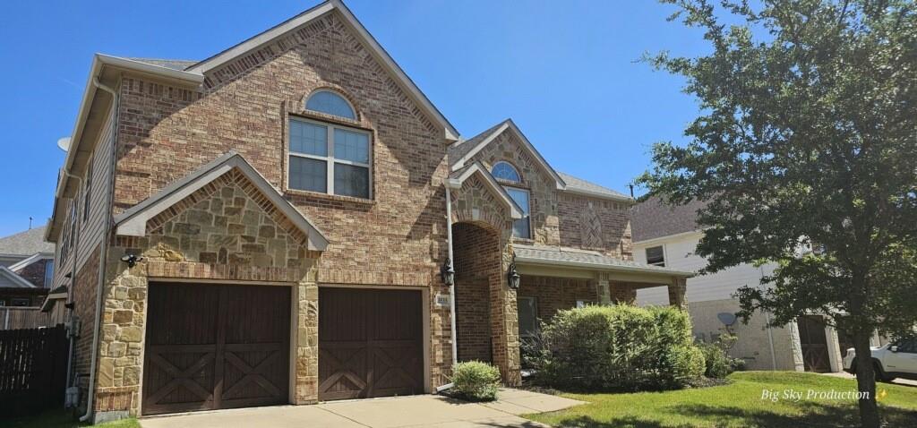 a view of a brick house next to a yard