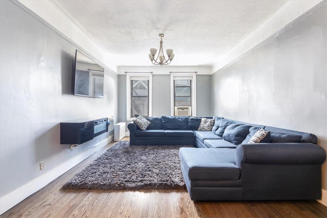 a living room with furniture and a chandelier