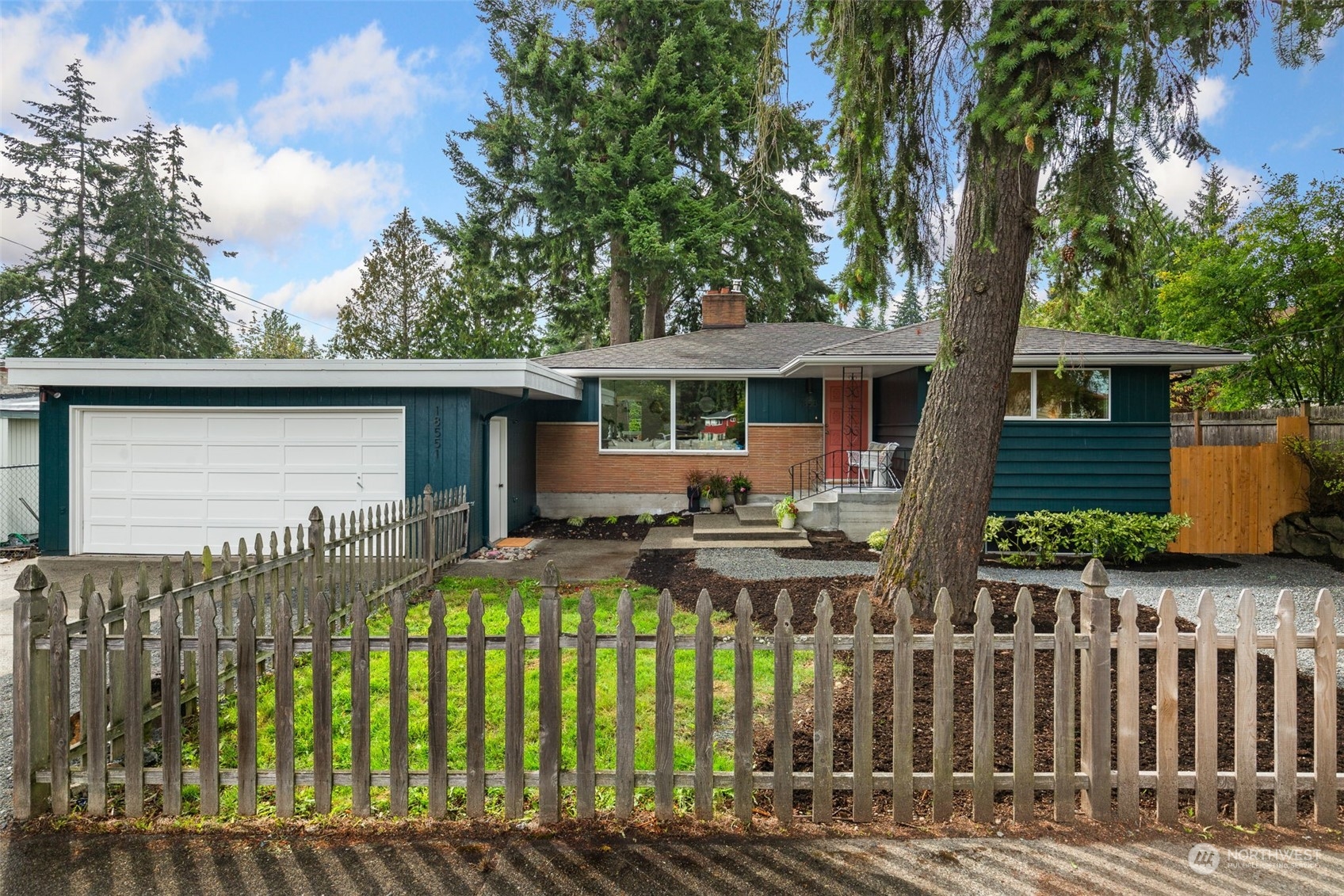 a view of house with wooden deck and furniture