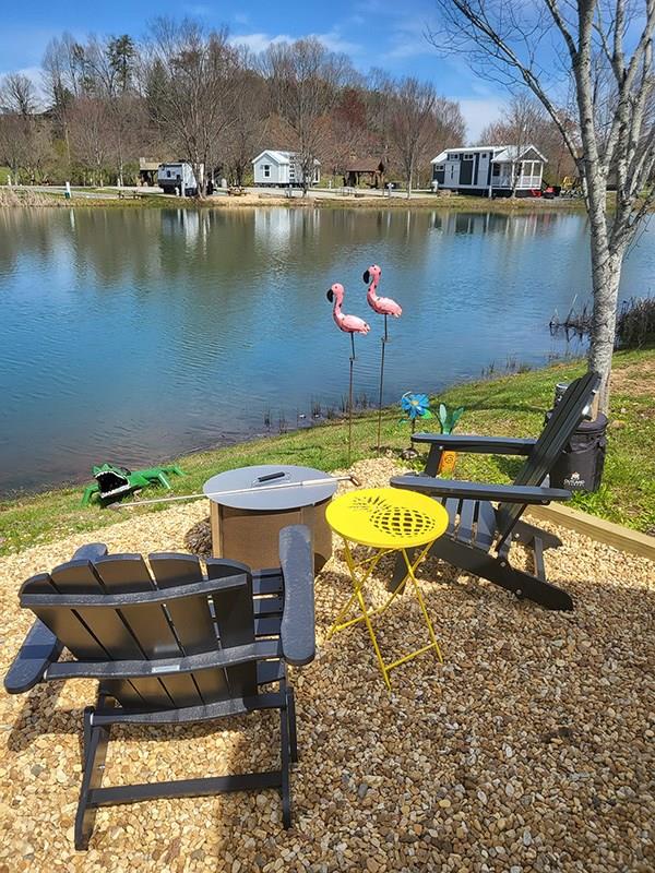 a view of a lake with a table and chairs