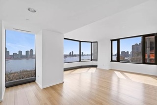 a view of a big room with wooden floor windows and a living room