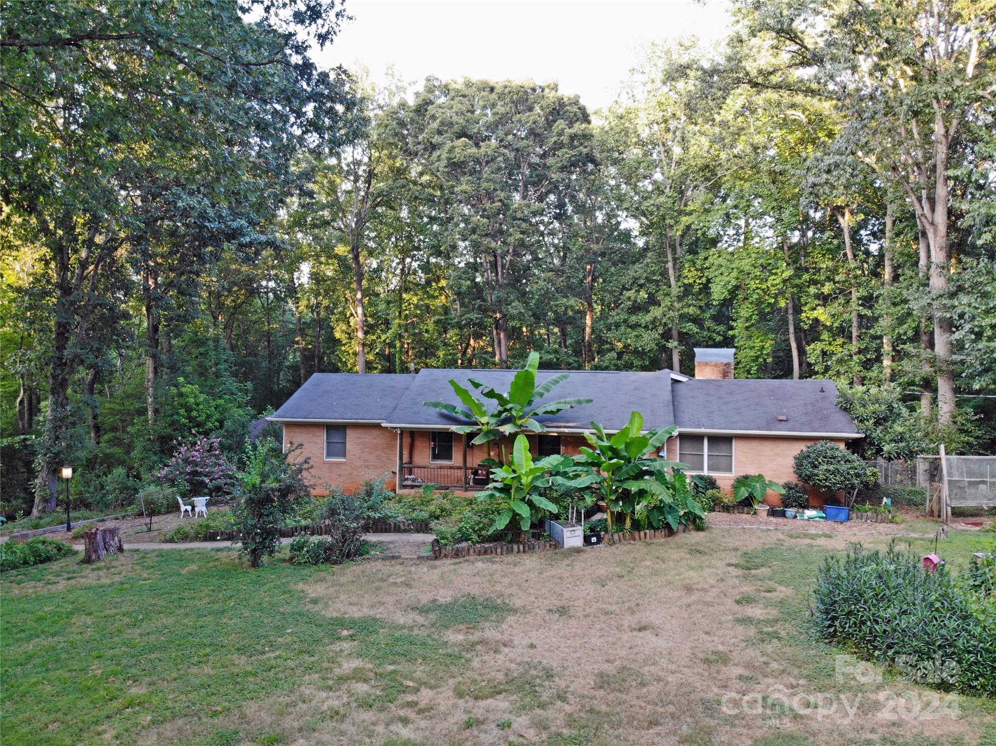 a front view of a house with a garden