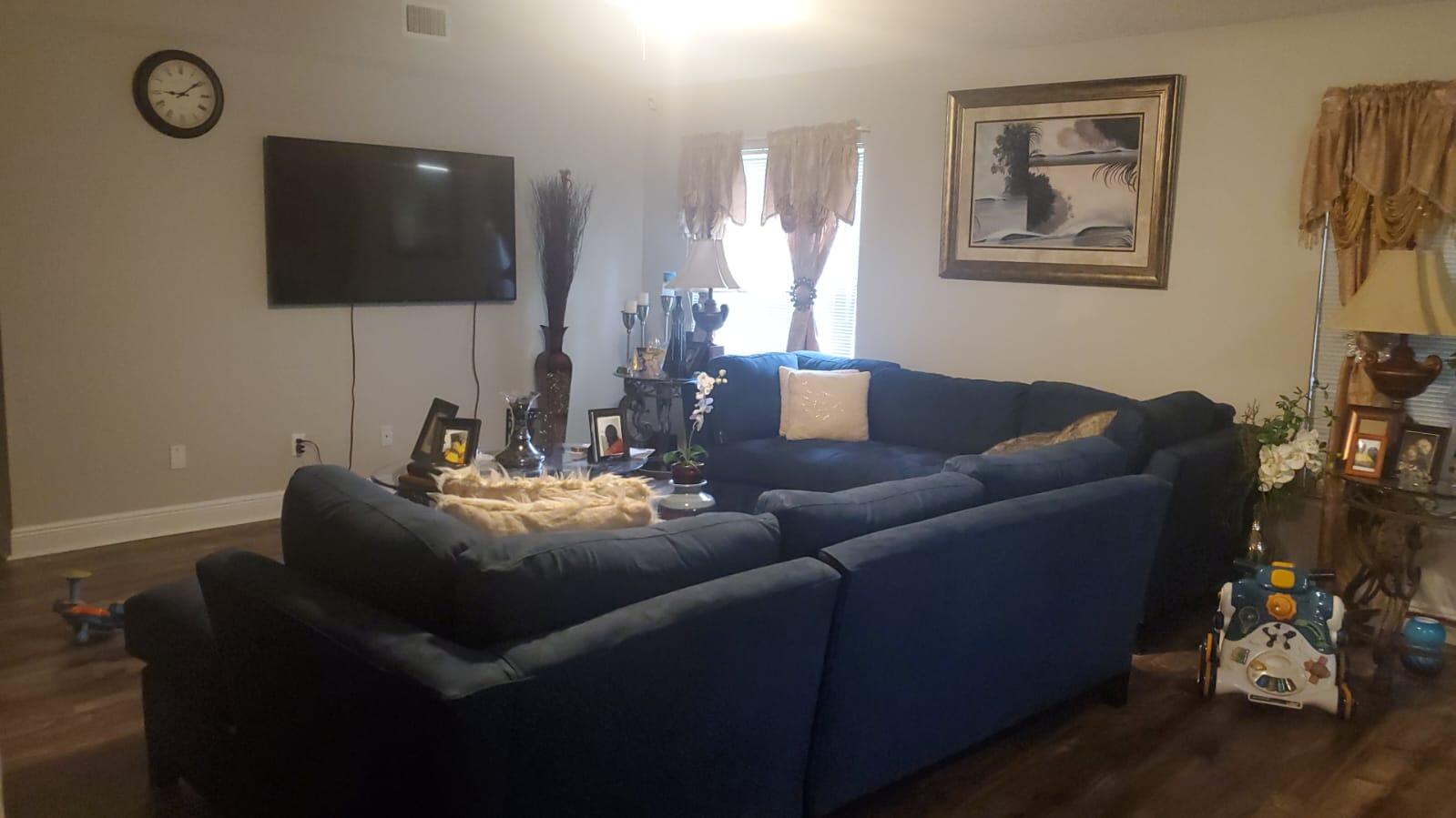 a living room with furniture and a flat screen tv