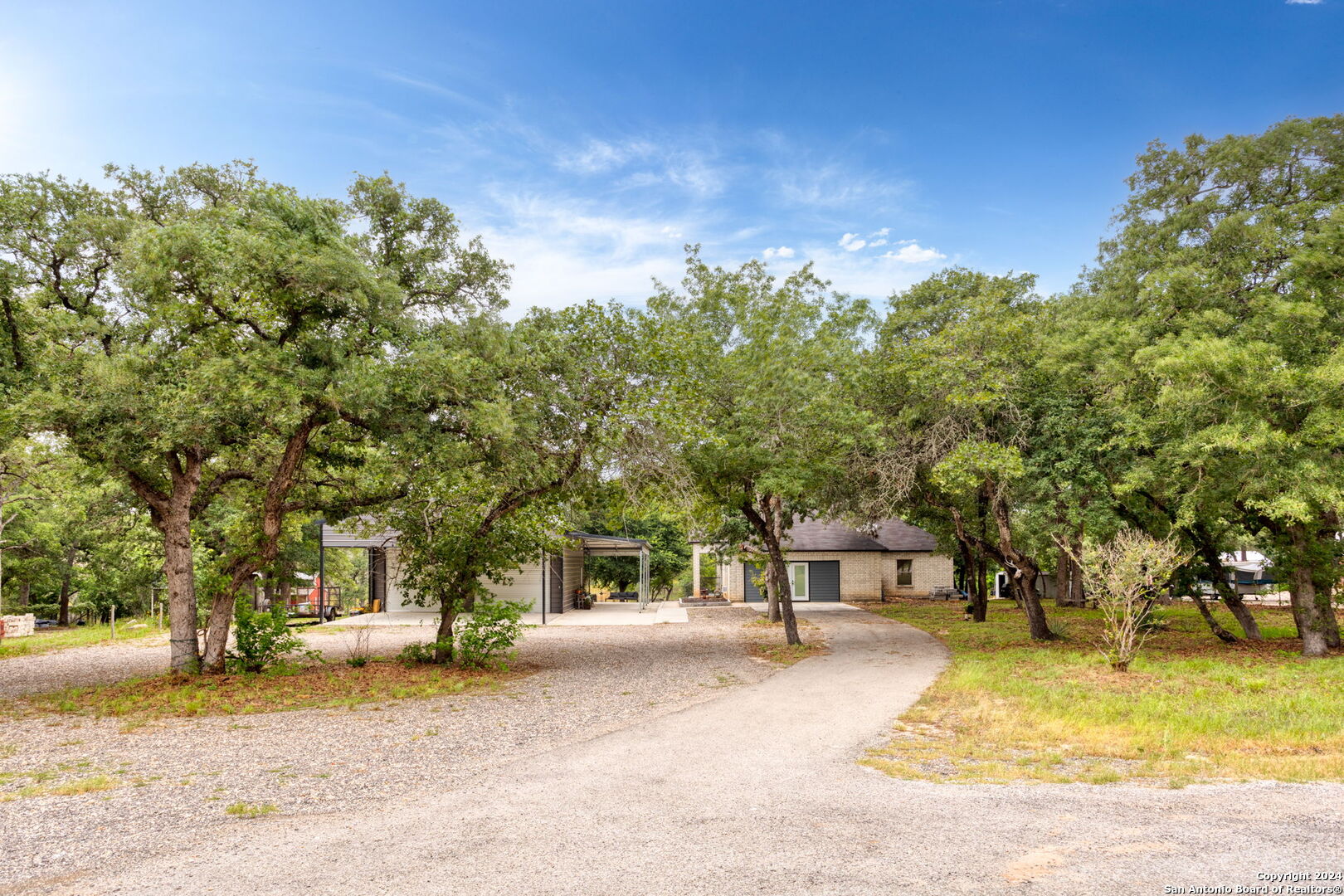 a view of a house with a tree in the background