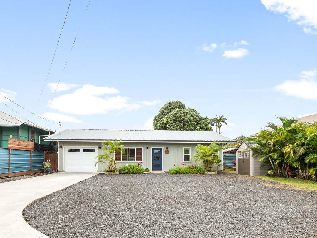 a front view of house with a garden