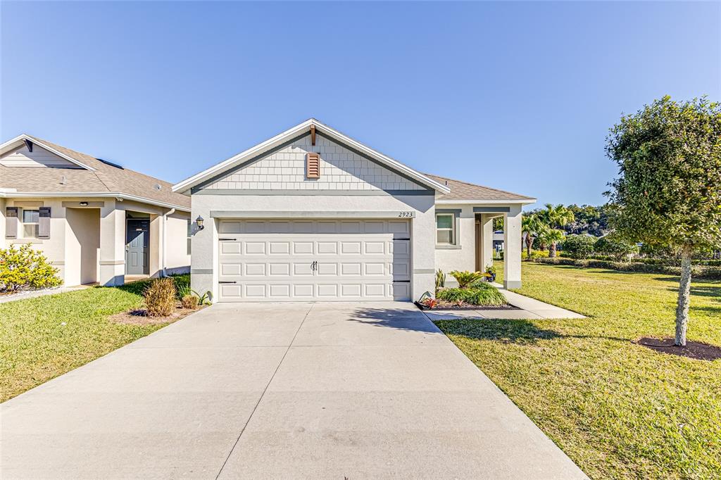 a front view of a house with a yard and garage