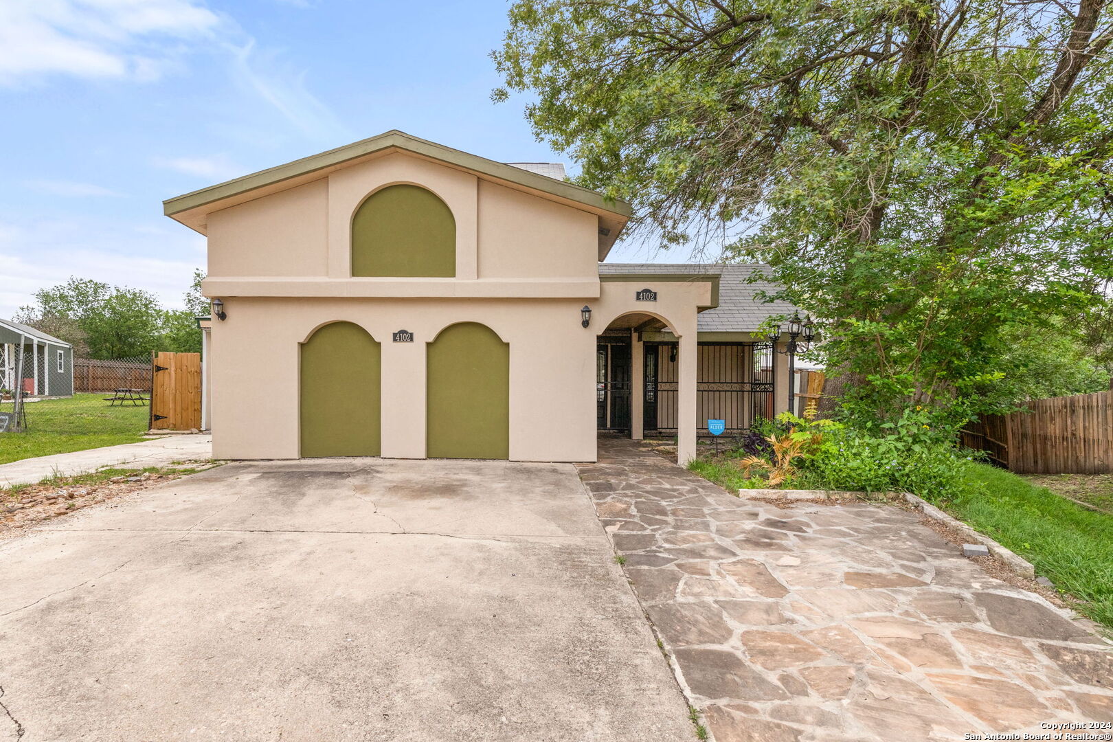 a front view of a house with garden