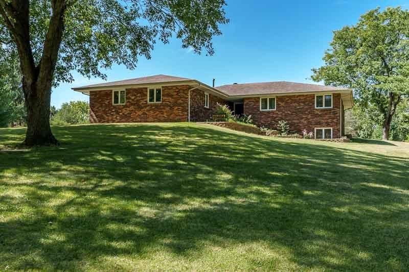 a front view of house with yard barbeque and outdoor seating