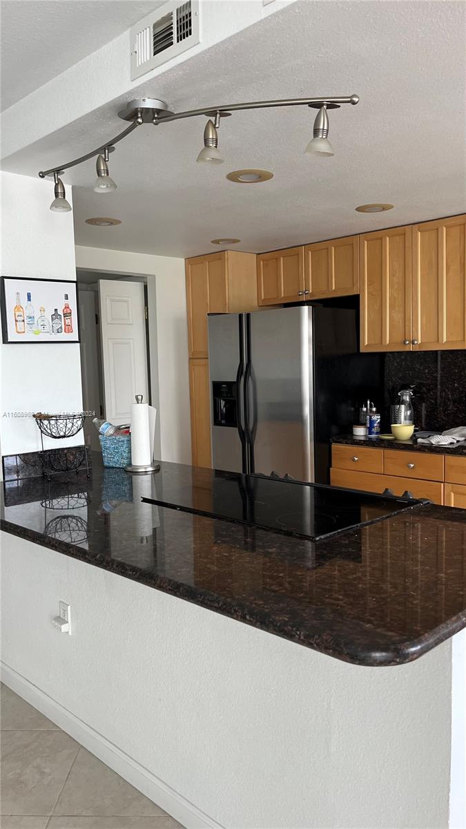 a kitchen with kitchen island a sink a counter and cabinets