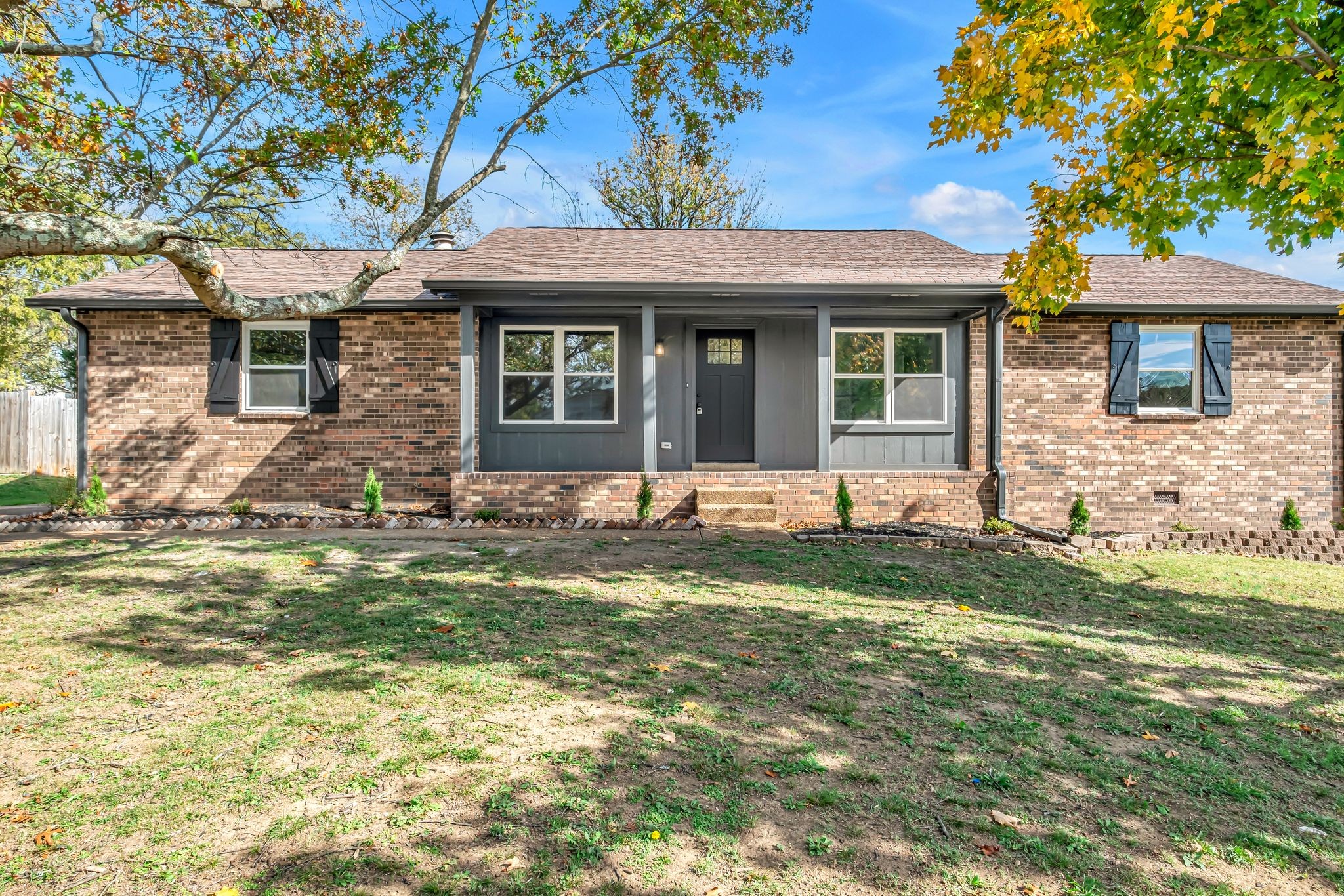 a front view of a house with a yard and porch