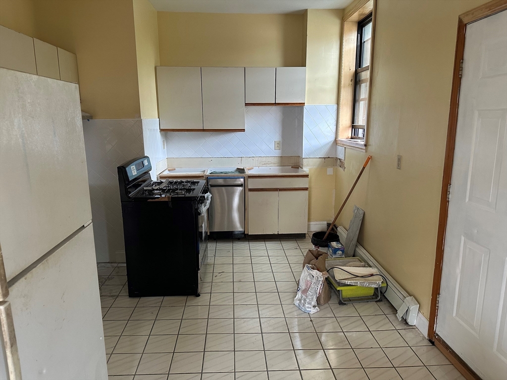 a kitchen with a sink a stove and a refrigerator