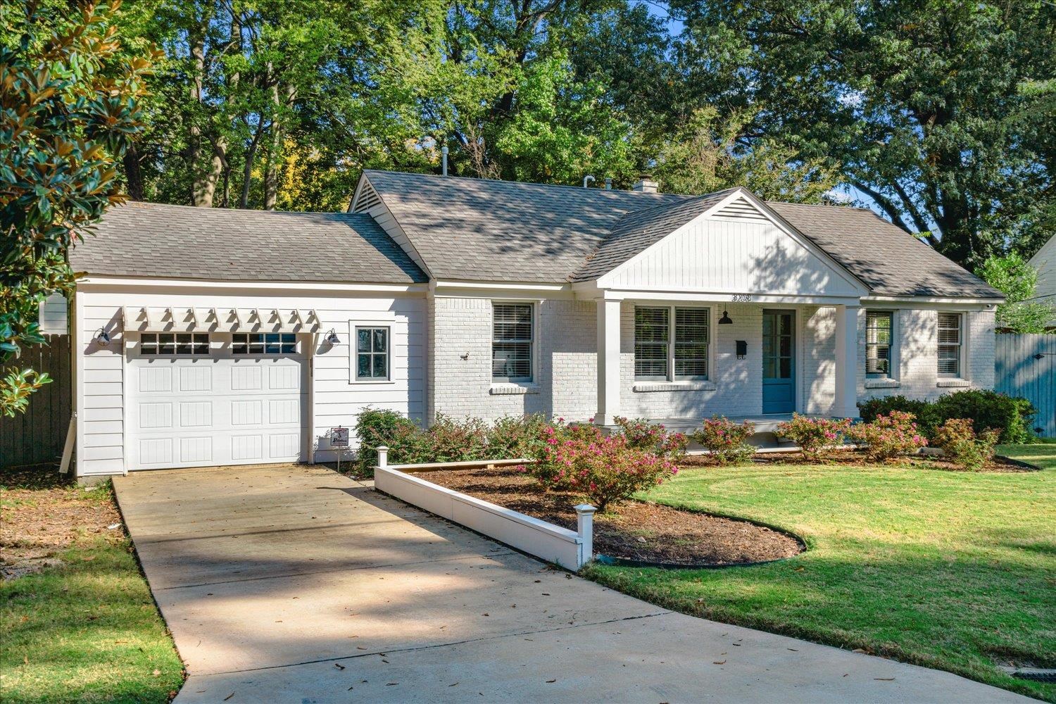 View of front of house featuring a front yard and a garage