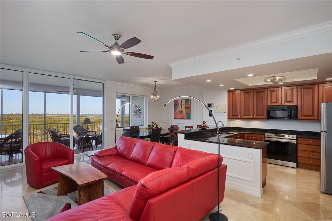 a living room with furniture kitchen view and large windows