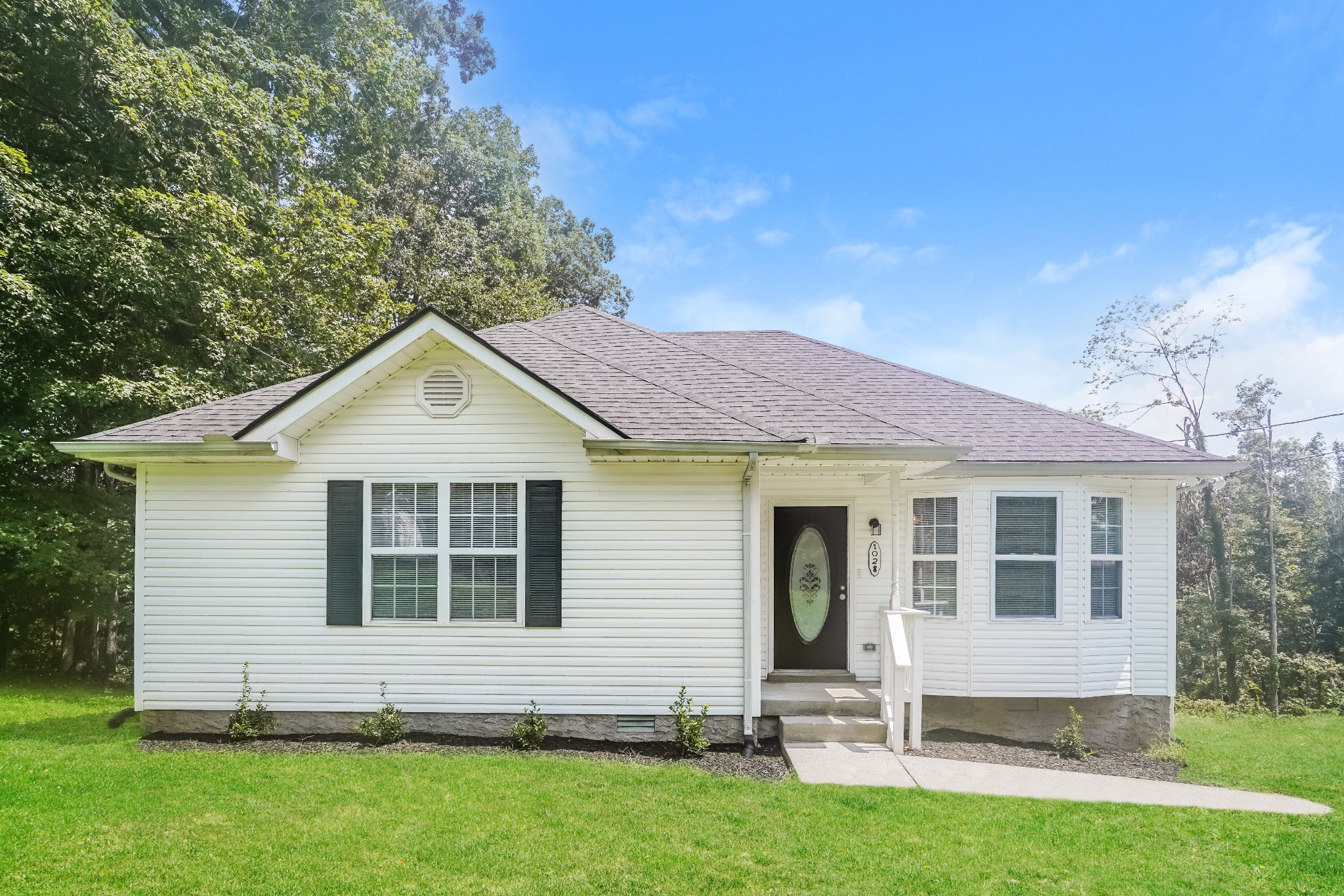 a front view of a house with a yard