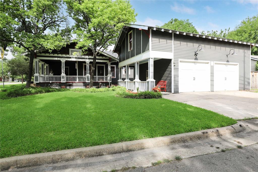 a front view of house with yard and outdoor seating