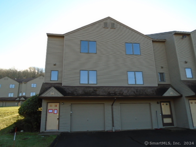 a front view of a house with parking space