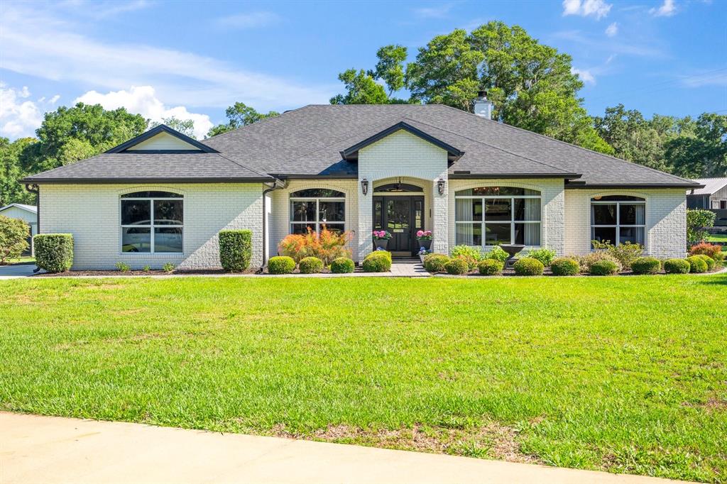 a front view of house with yard and green space