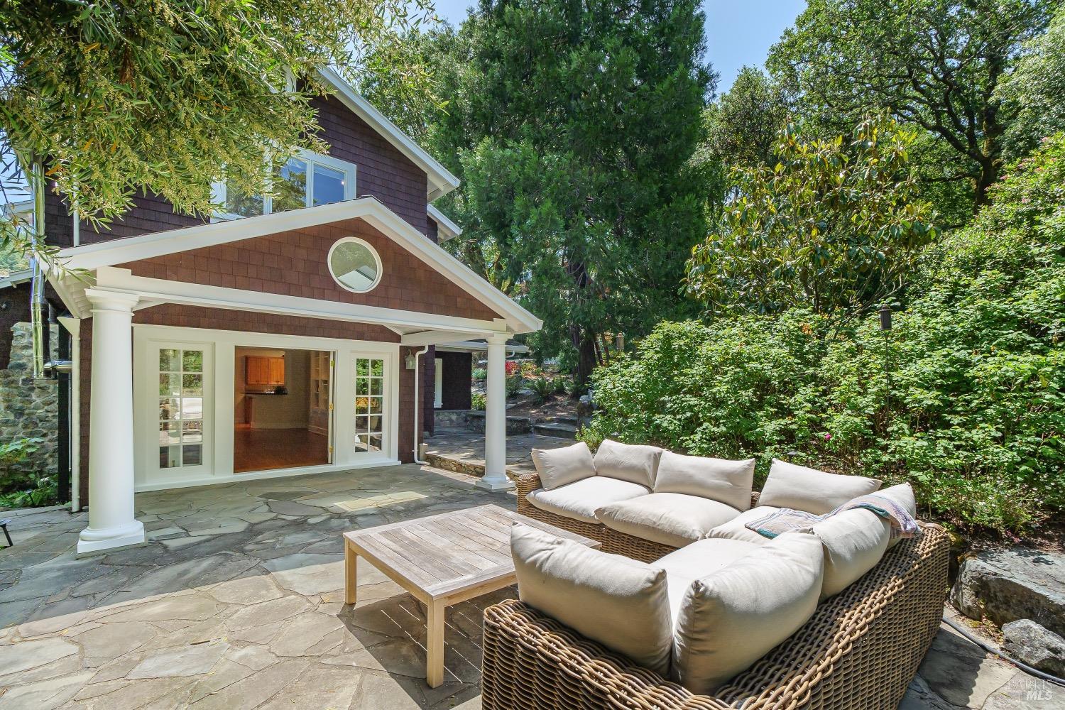 a view of a house with a chairs and table in a patio