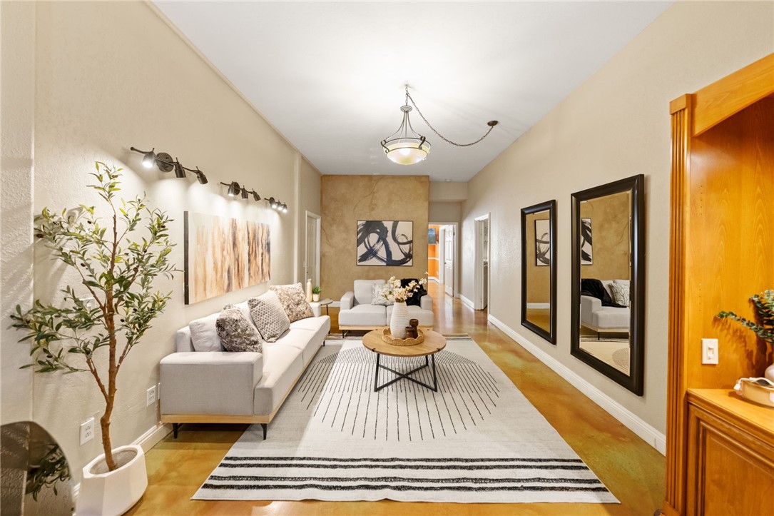 a living room with furniture and wooden floor