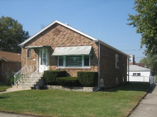 a front view of house with yard and outdoor seating