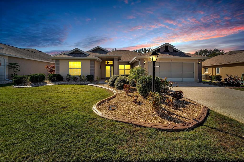 a view of a house with a big yard and potted plants