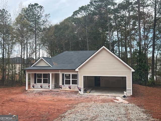 a front view of house with yard and trees in the background