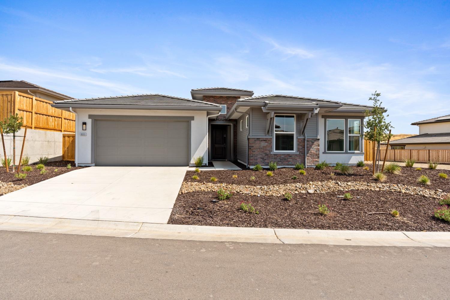 a front view of a house with garage