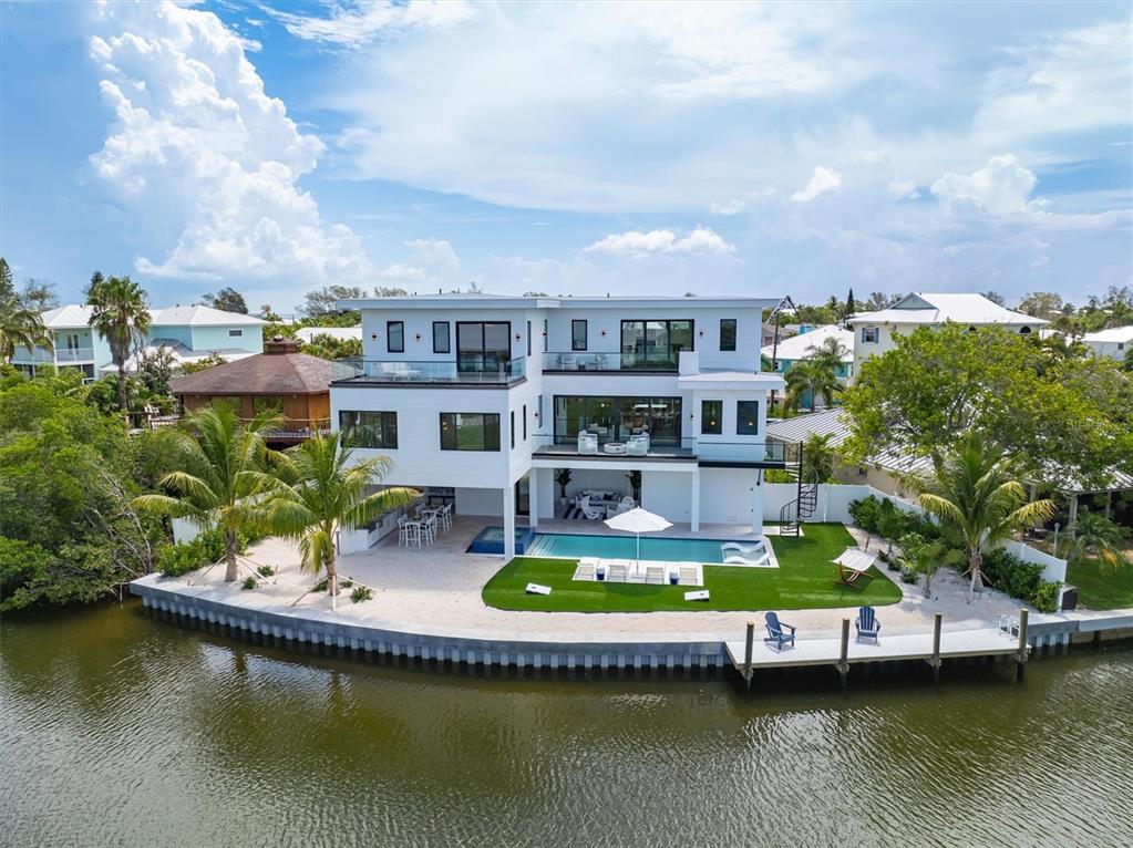 an aerial view of house with yard swimming pool and outdoor seating