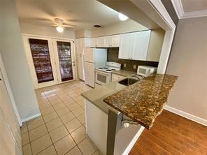 a kitchen with stainless steel appliances granite countertop a stove top oven a sink a counter space and cabinets