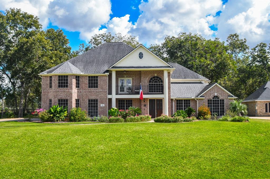 a front view of house with yard and green space