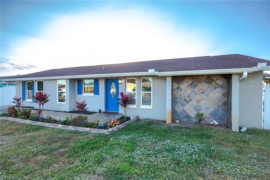 Single story home featuring a front lawn