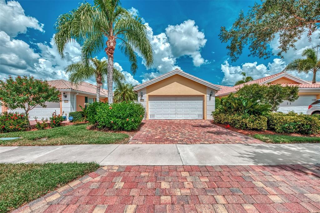 a front view of a house with a yard and a garage