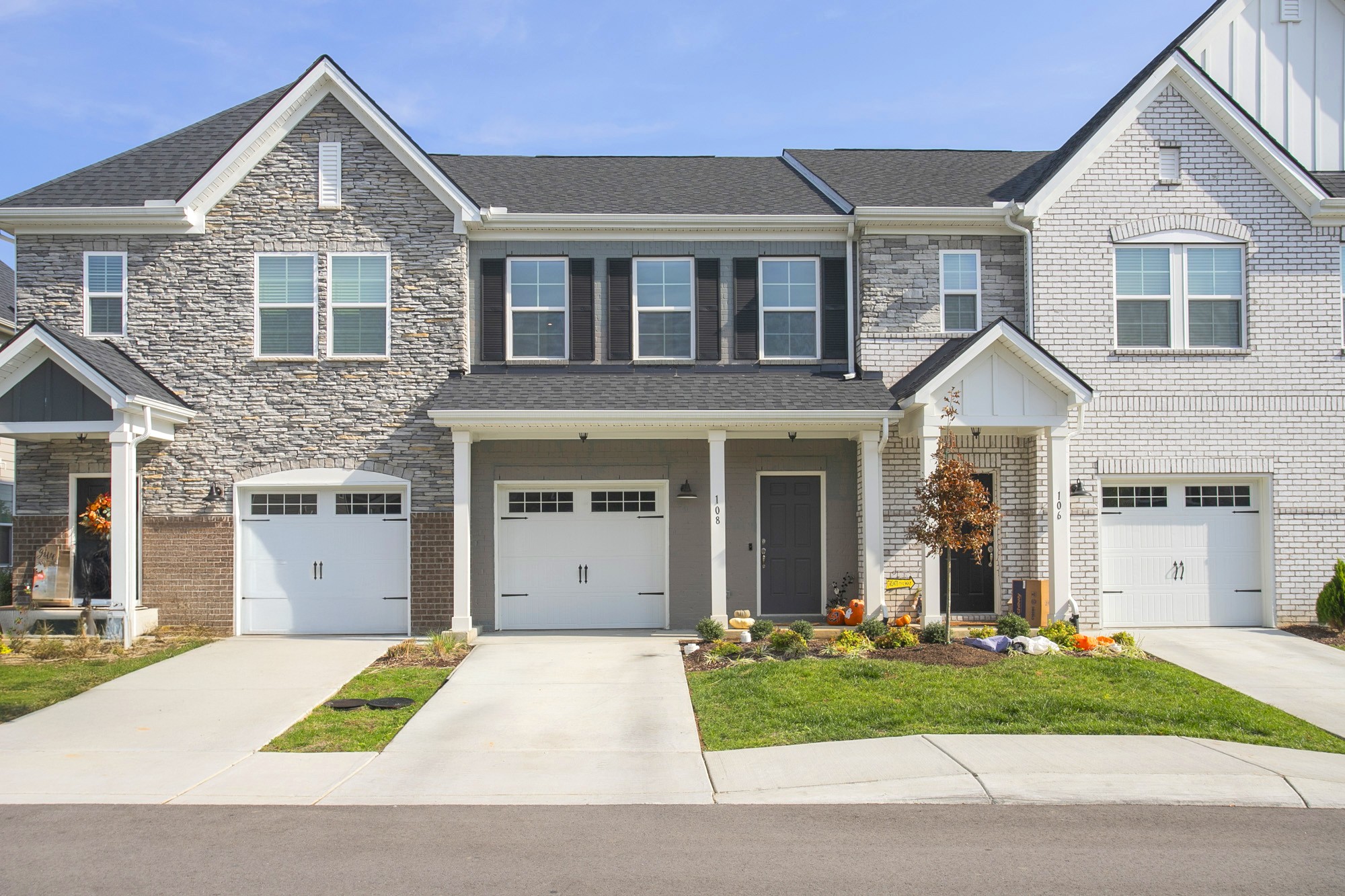 a view of a house with a yard and large parking space