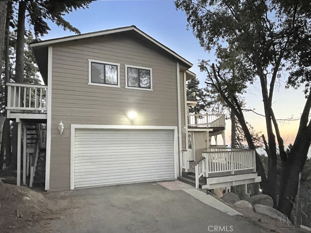 a view of a house with a yard and garage