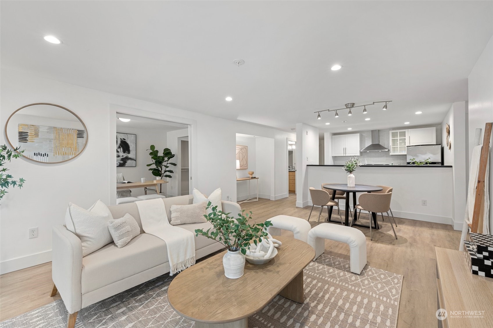 a living room with furniture kitchen and a table